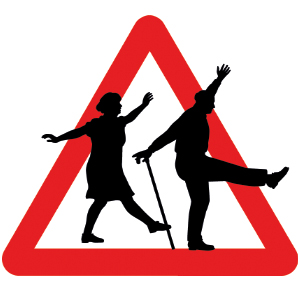 Older man and woman dancing across a warning sign