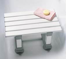 An image of a white slatted bath seat, with suction cups on the feet to suction to the bottom of the bath.