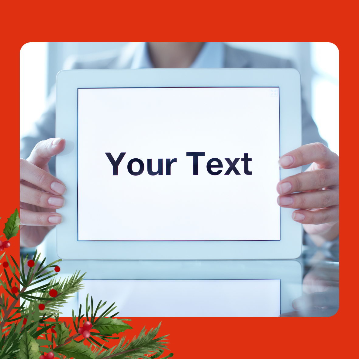 An image of a tablet being held up to the camera, with the words Your Text. The image is on a red background and there is holly and berries in the left bottom corner. 
