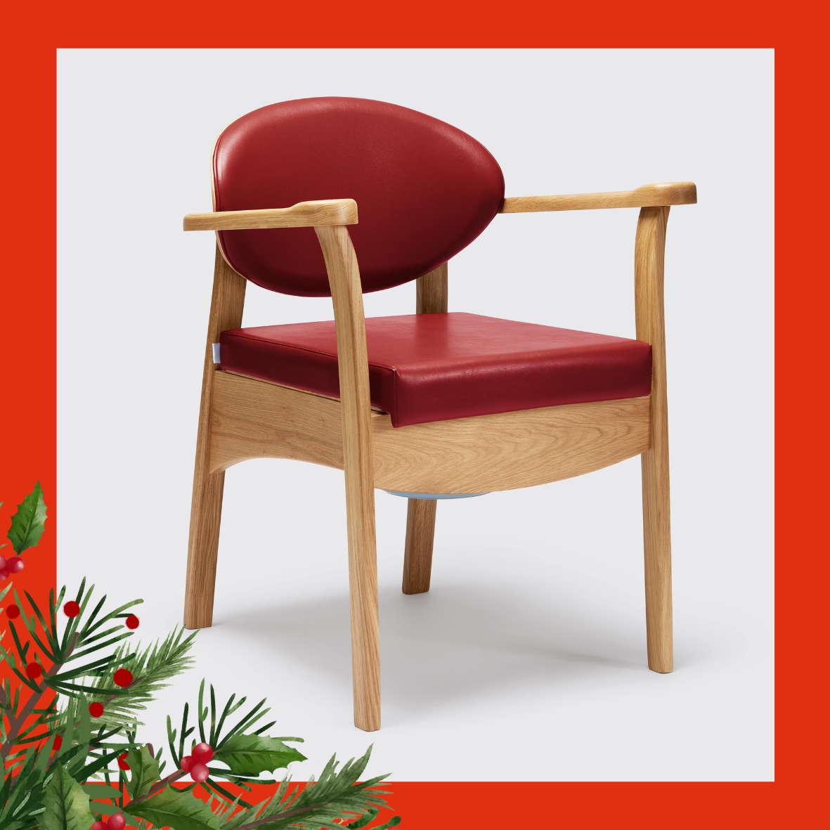 An image of the commode chair, which is a wooden chair with a red leather seat and back rest. 