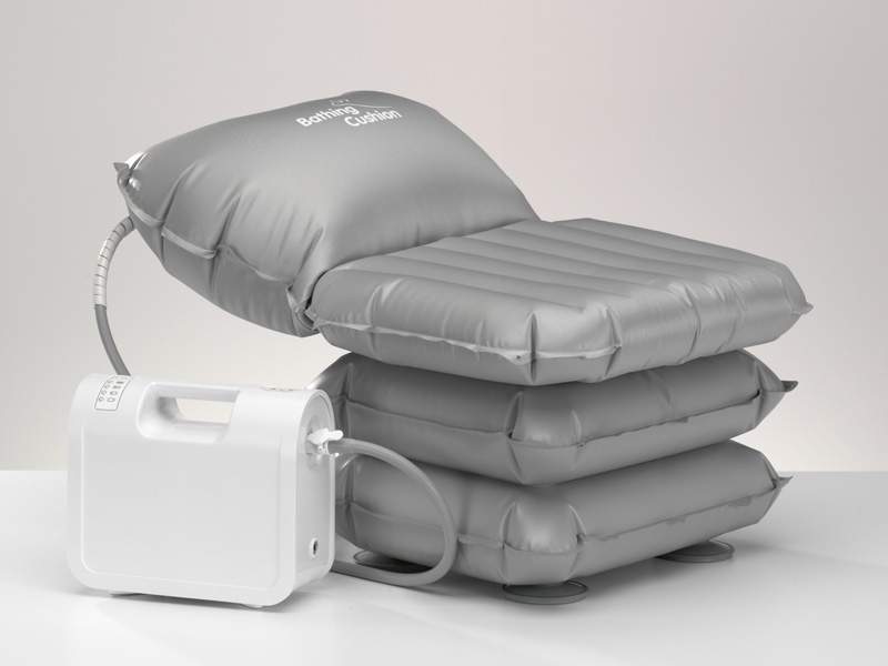 An image of a silver coloured inflatable bed type cushion bath lift It is attached to a motor so it can inflate and lift and lower.