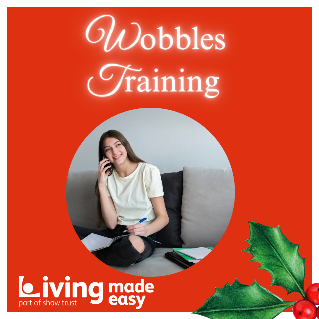 Door number 14 reveals an image of a teenage girl, with long brunette hair, talking on the phone. She is using her other hand to make notes in a notebook and is sat crossed legged on a sofa. There is holly and berries in the left hand corner. Above the image are the words Wobbles Training.