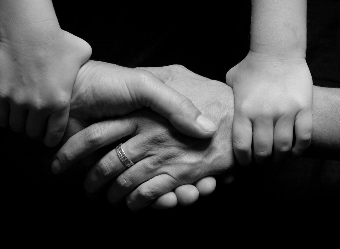 Hands reaching across to eachother