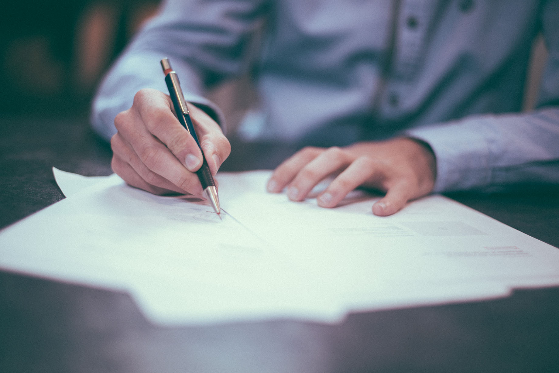 Person working, signing documents