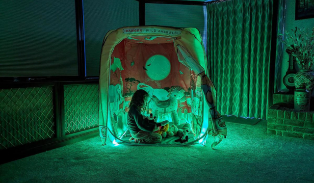 Child playing in safari themed pod with green lighting