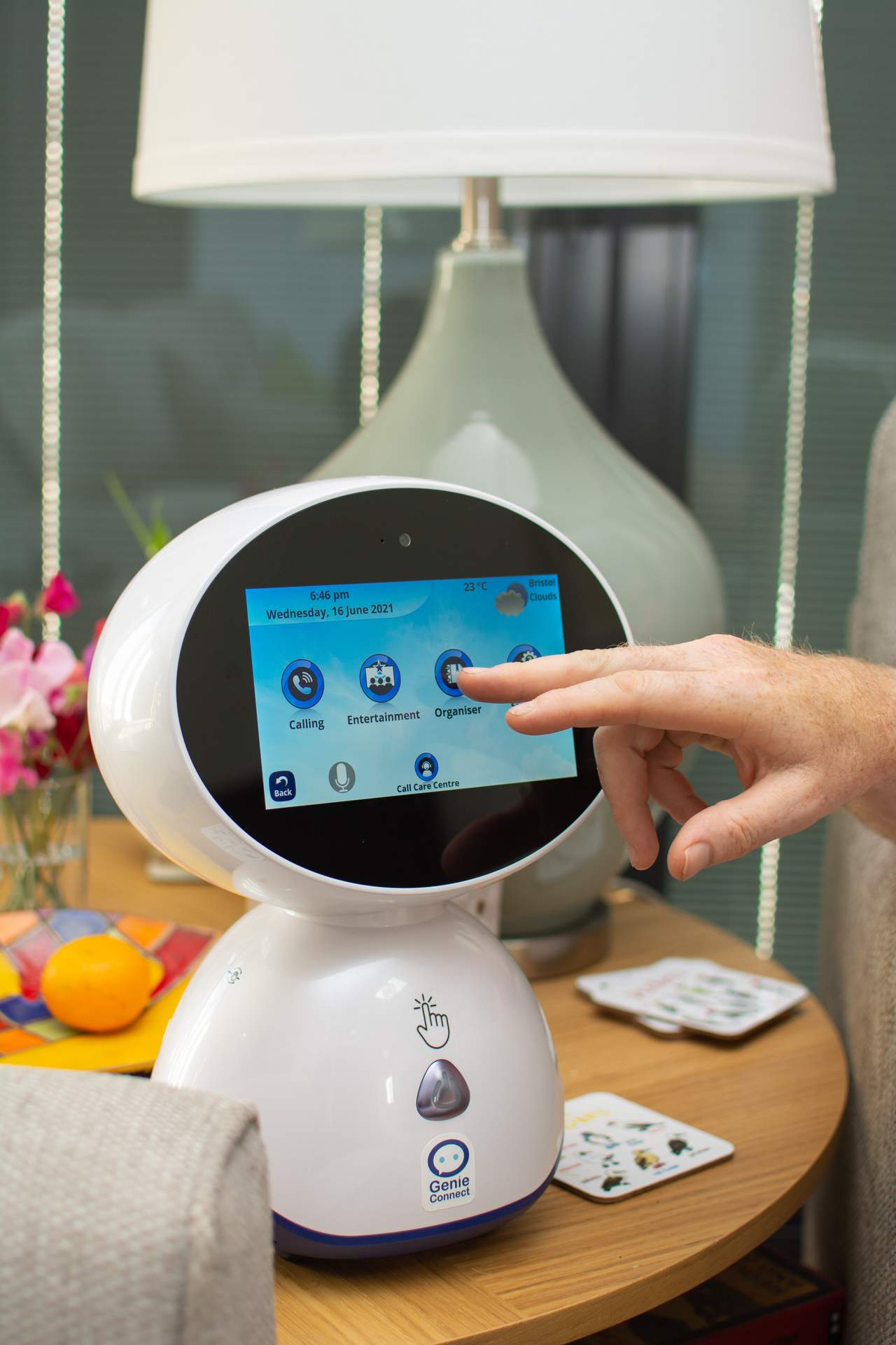 finger pressing button on touch screen device on Genie the robot