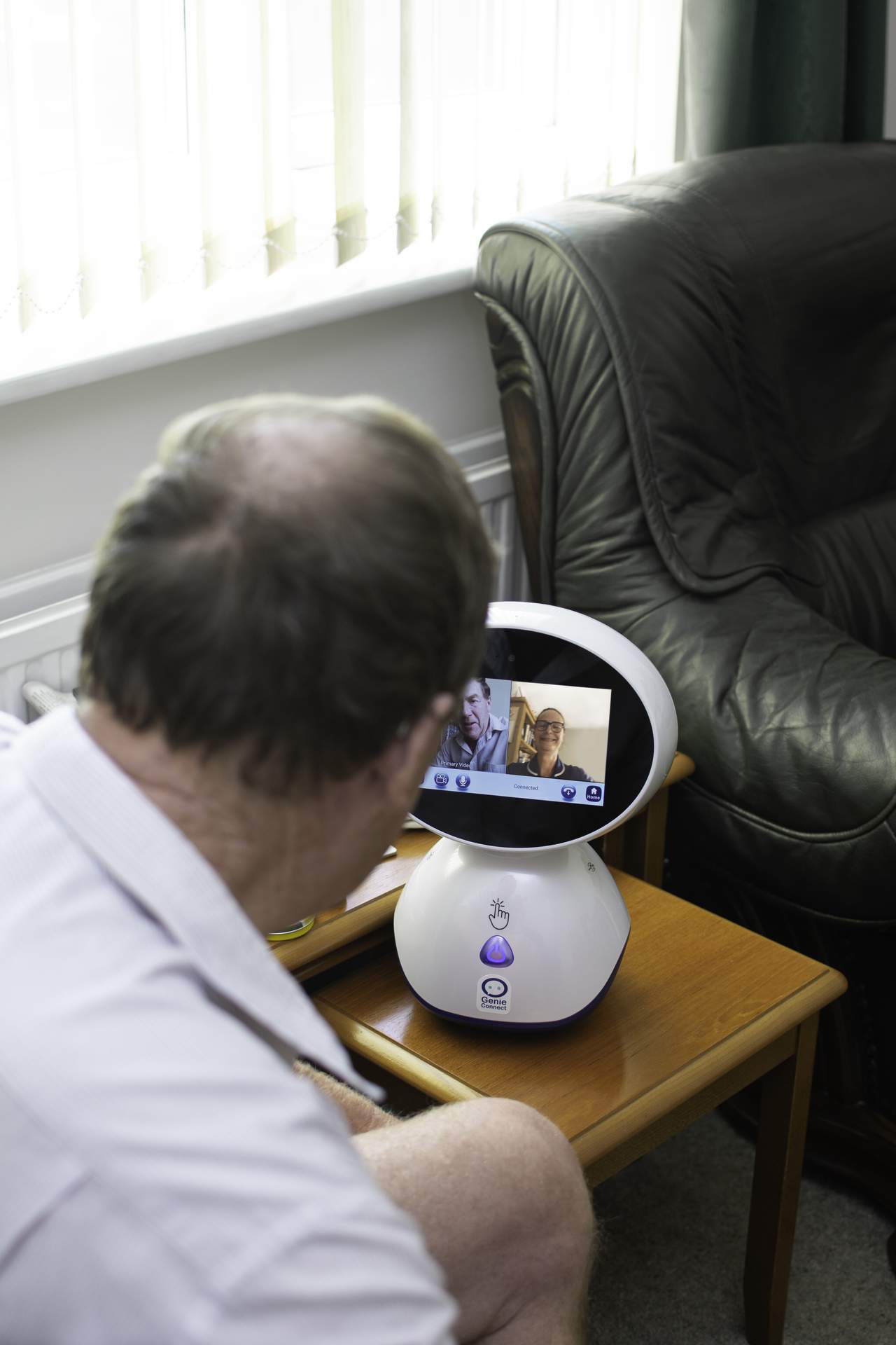 Person using the Genie robot in Living room