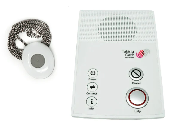 White personal alarm button on necklace with white receiver box next to it.