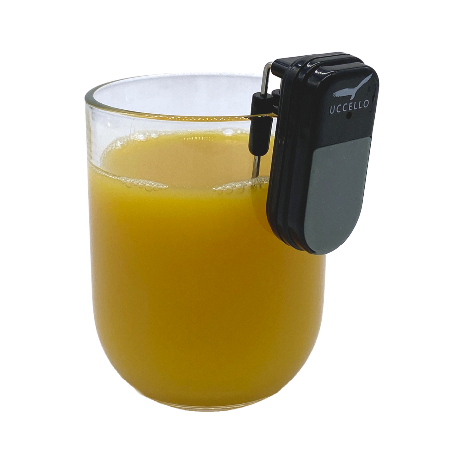 Liquid Level Indicator sitting on the rim of a small glass of orange juice