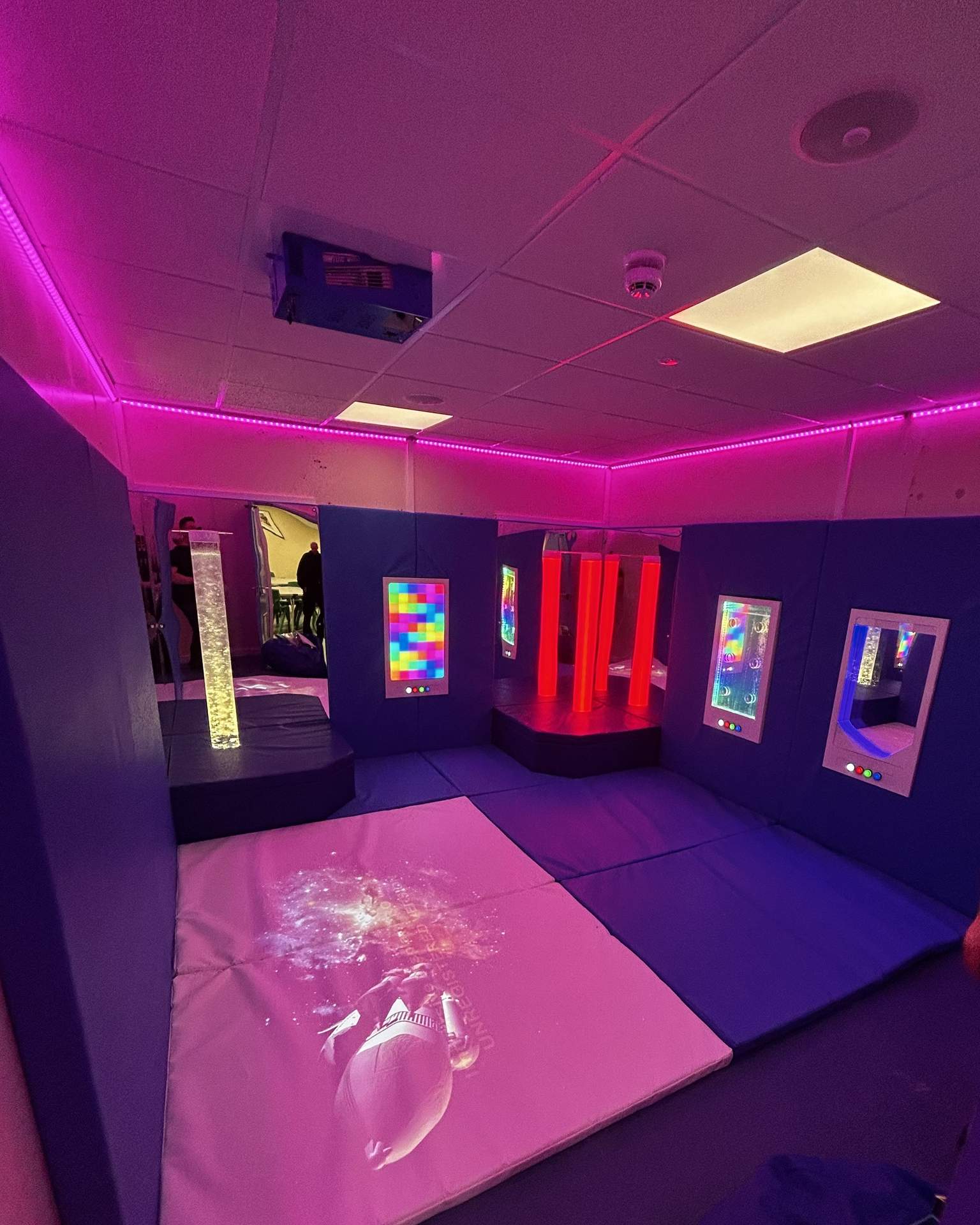 SENse Tile installed into a sensory room, producing a bright interactive image on the floor