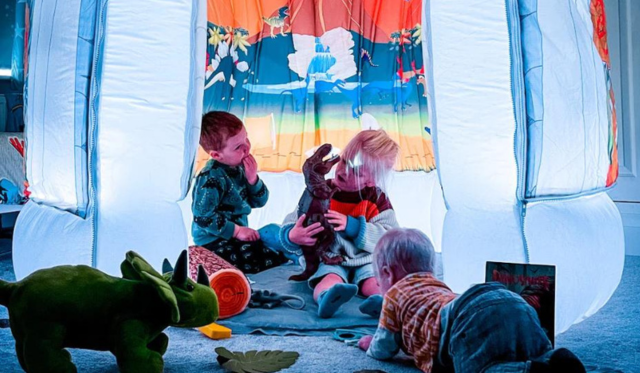 Three children playing in Dinosaur themed pod