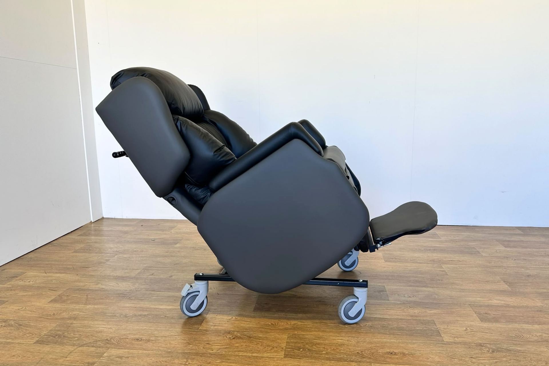 Astro Dinton Care Chair  Side view tilted with leg rest down