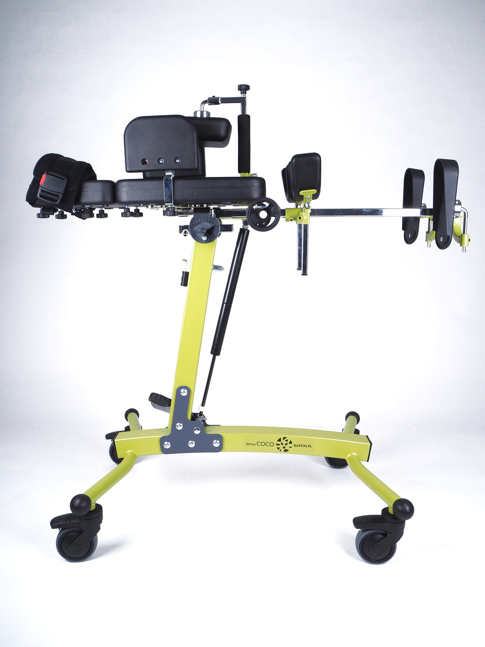 Green frame COCO stander with black cushioning in laying position. 